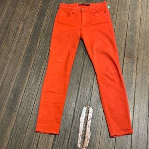 Joe’s jeans, skinny, in a reddish orange.